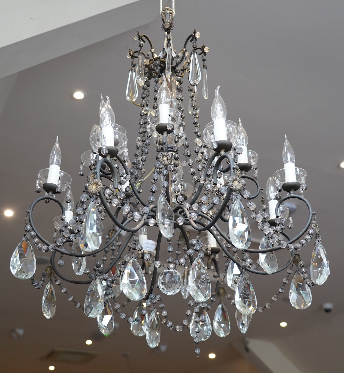 A two tier chandelier with eight branches on each tier, together with a pair of three branch wall lights, chandelier approximately 73cm high
